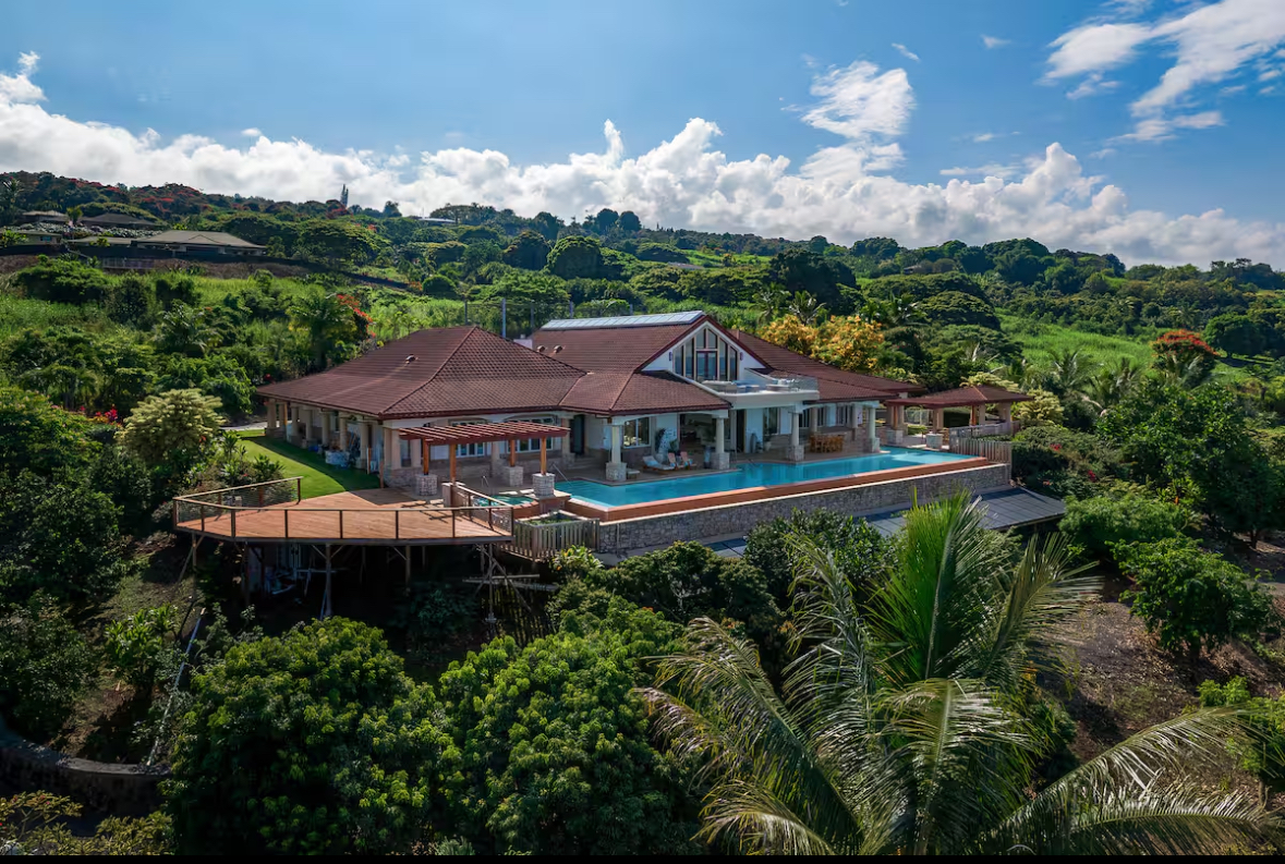 Aerial view of the ocean-view retreat center and infinity pool above Kona