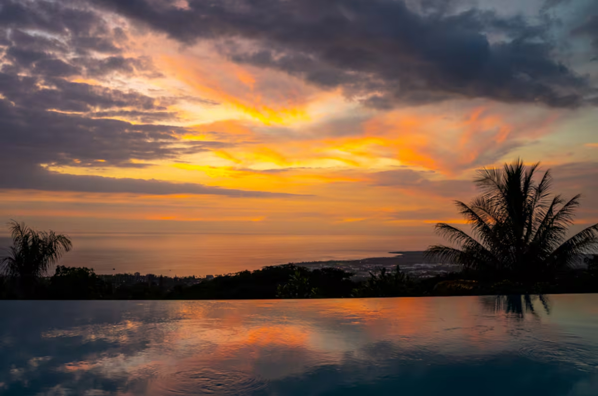 Fiery sunset reflected across the infinity pool