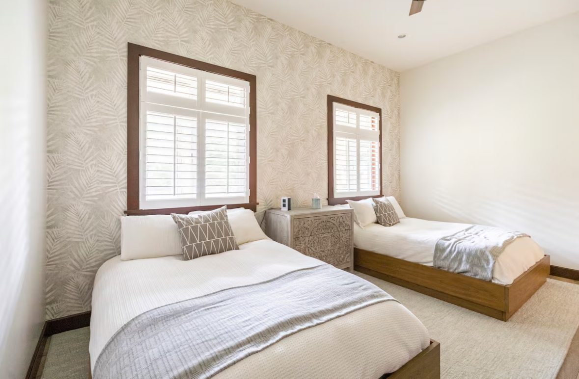 Bedroom with two single beds and soft neutral finishes