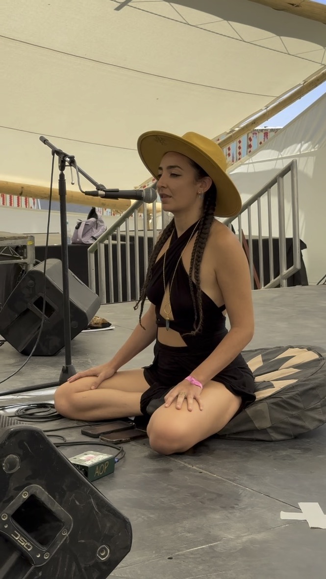 Dina leading a breathwork session on stage